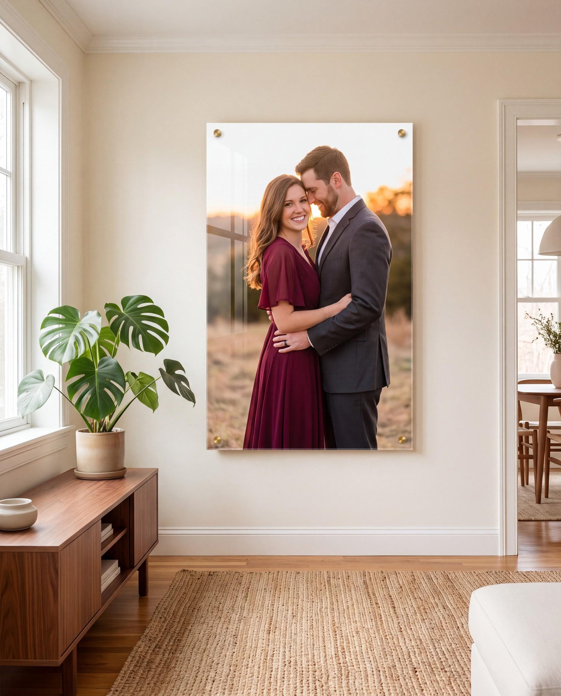 Custom acrylic photo print of a couple mounted with gold standoffs above a console table in a living room