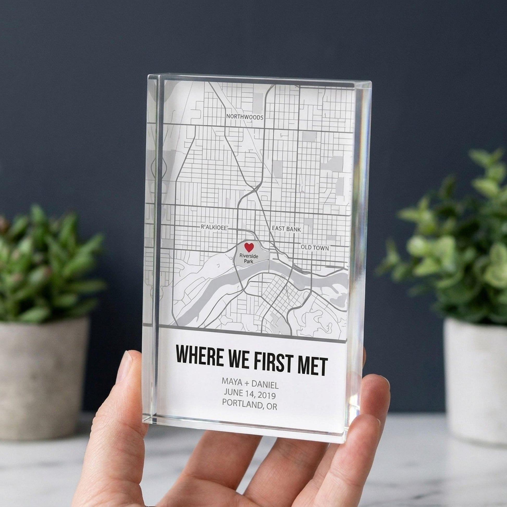 Hand holding a personalized location map acrylic block