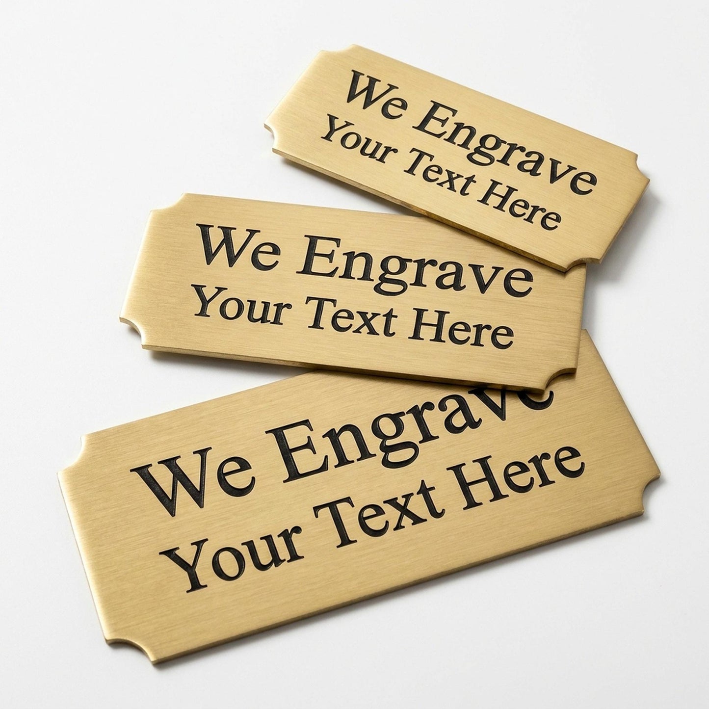 Engraved gold award plate nameplates with cut corners reading We Engrave Your Text Here, brushed brass finish