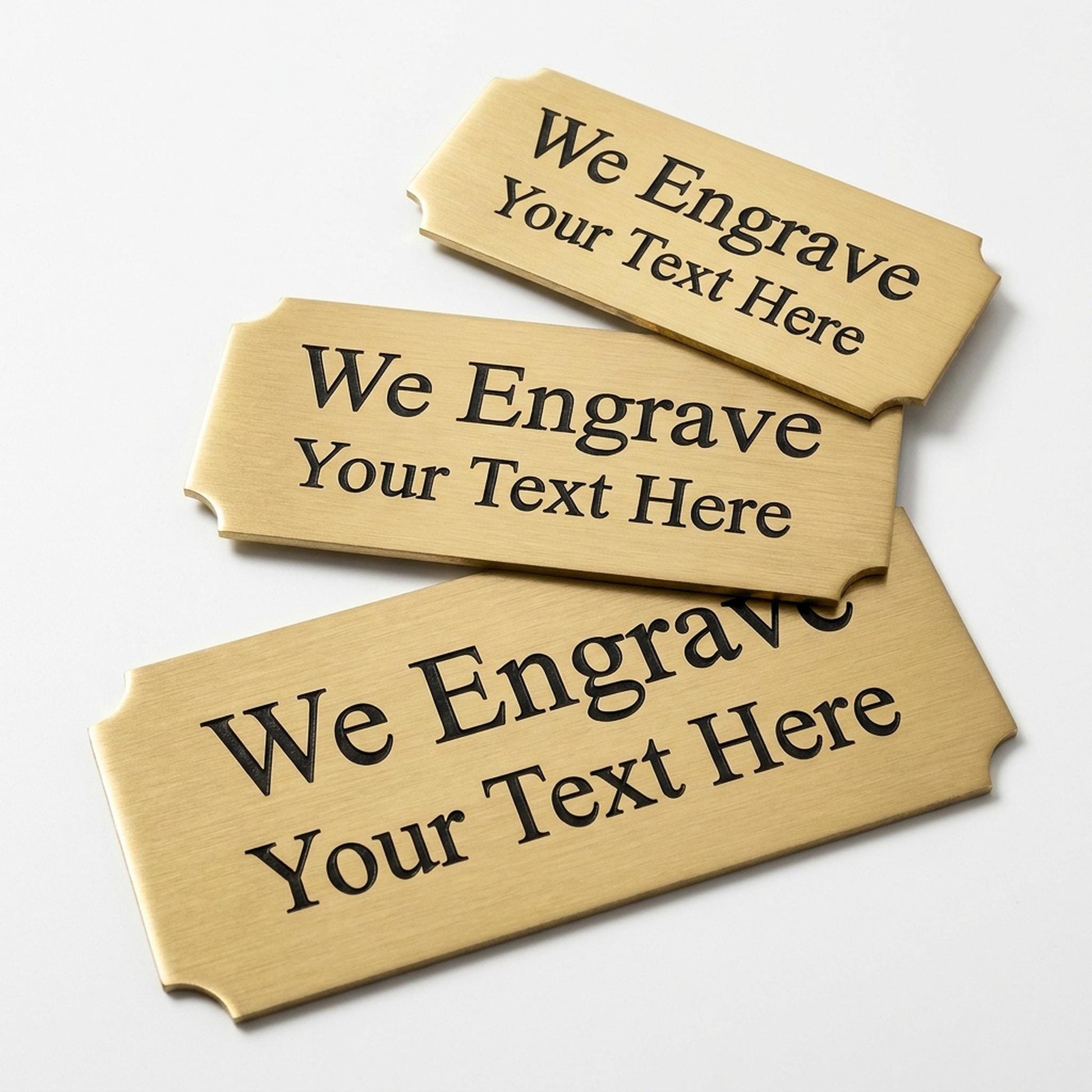 Engraved gold award plate nameplates with cut corners reading We Engrave Your Text Here, brushed brass finish