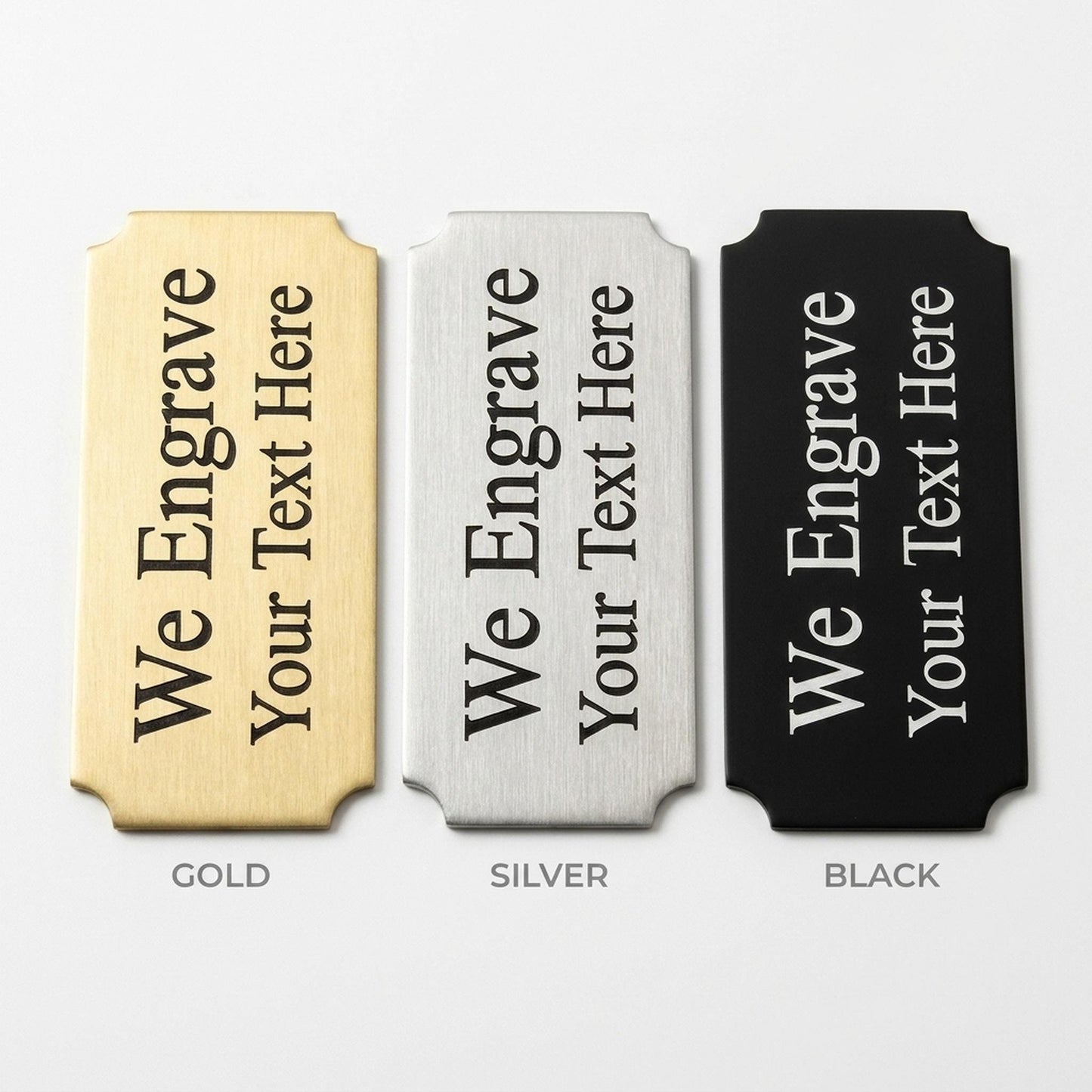 Engraved nameplate finish comparison showing gold, silver, and black metal options side by side