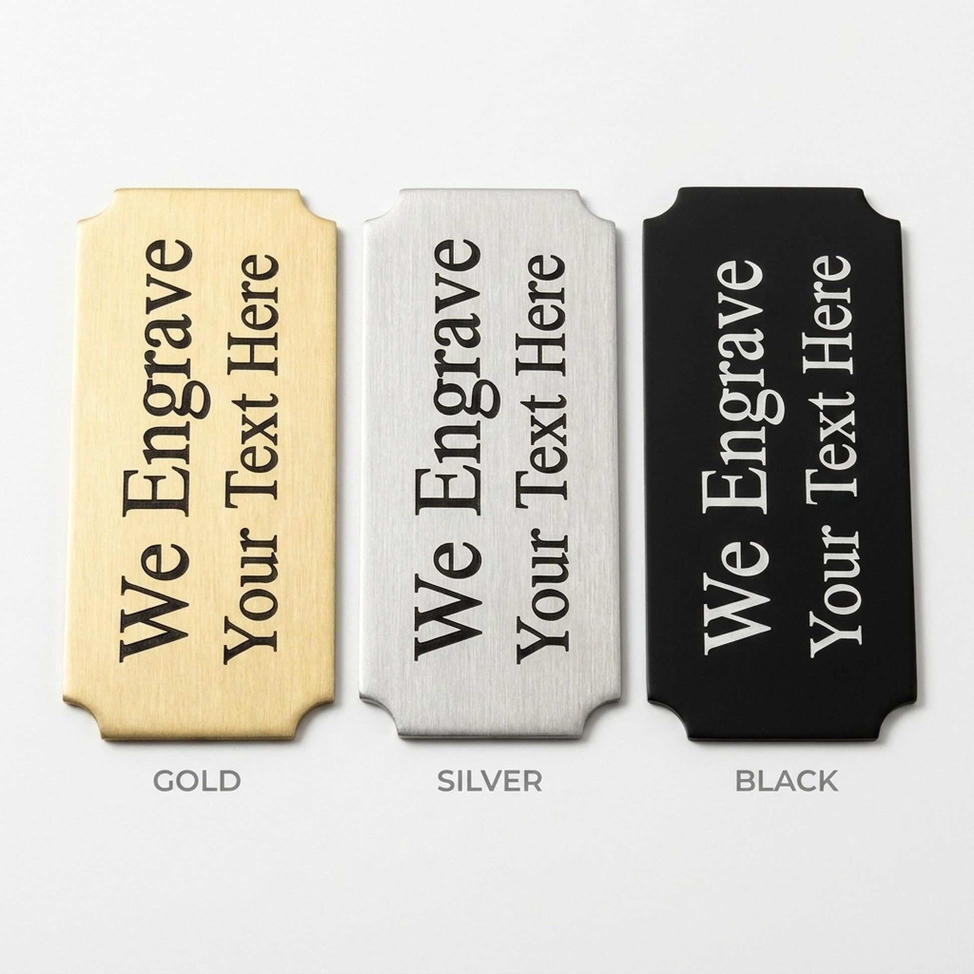 Engraved nameplate finish comparison showing gold, silver, and black metal options side by side