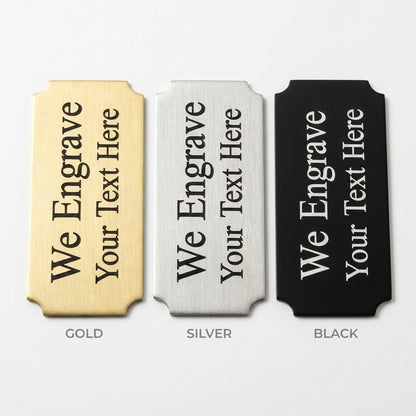 Engraved nameplate finish comparison showing gold, silver, and black metal options side by side