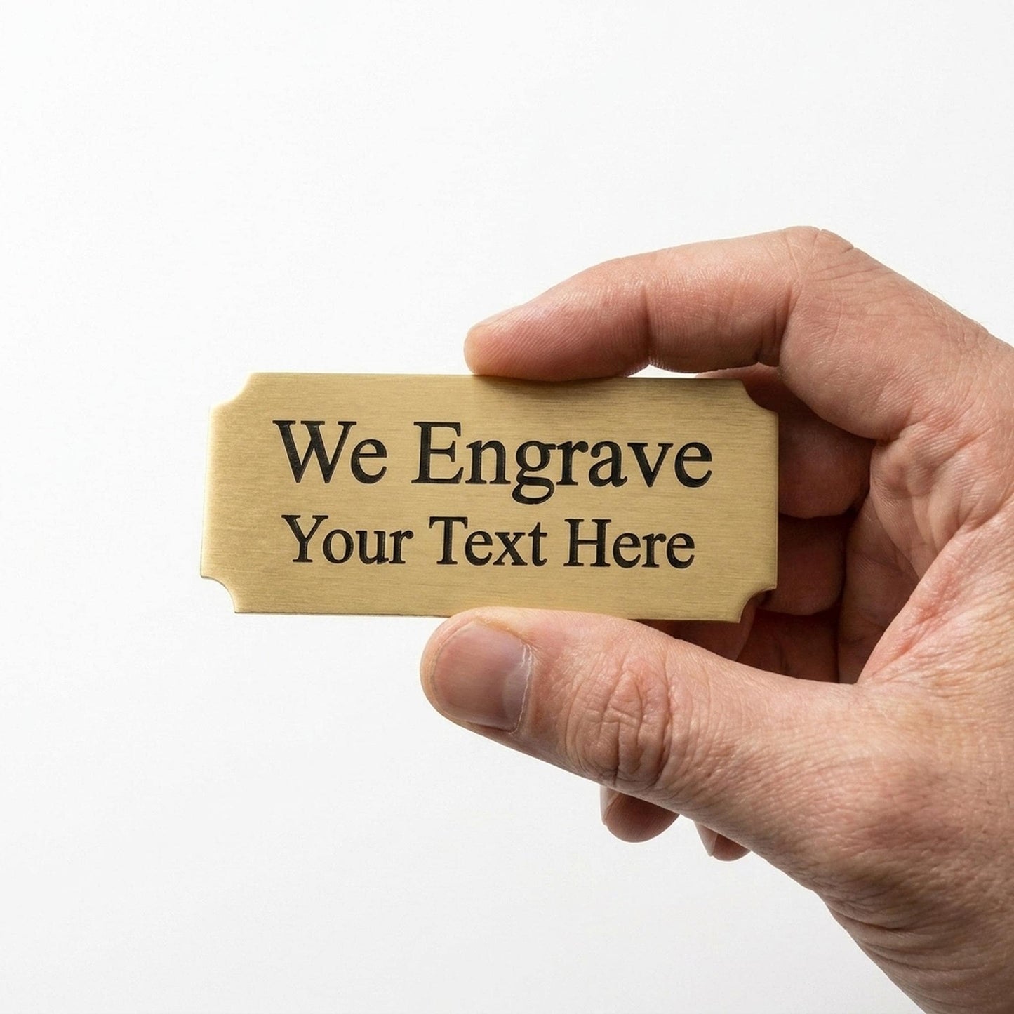 Hand holding a personalized engraved brass nameplate