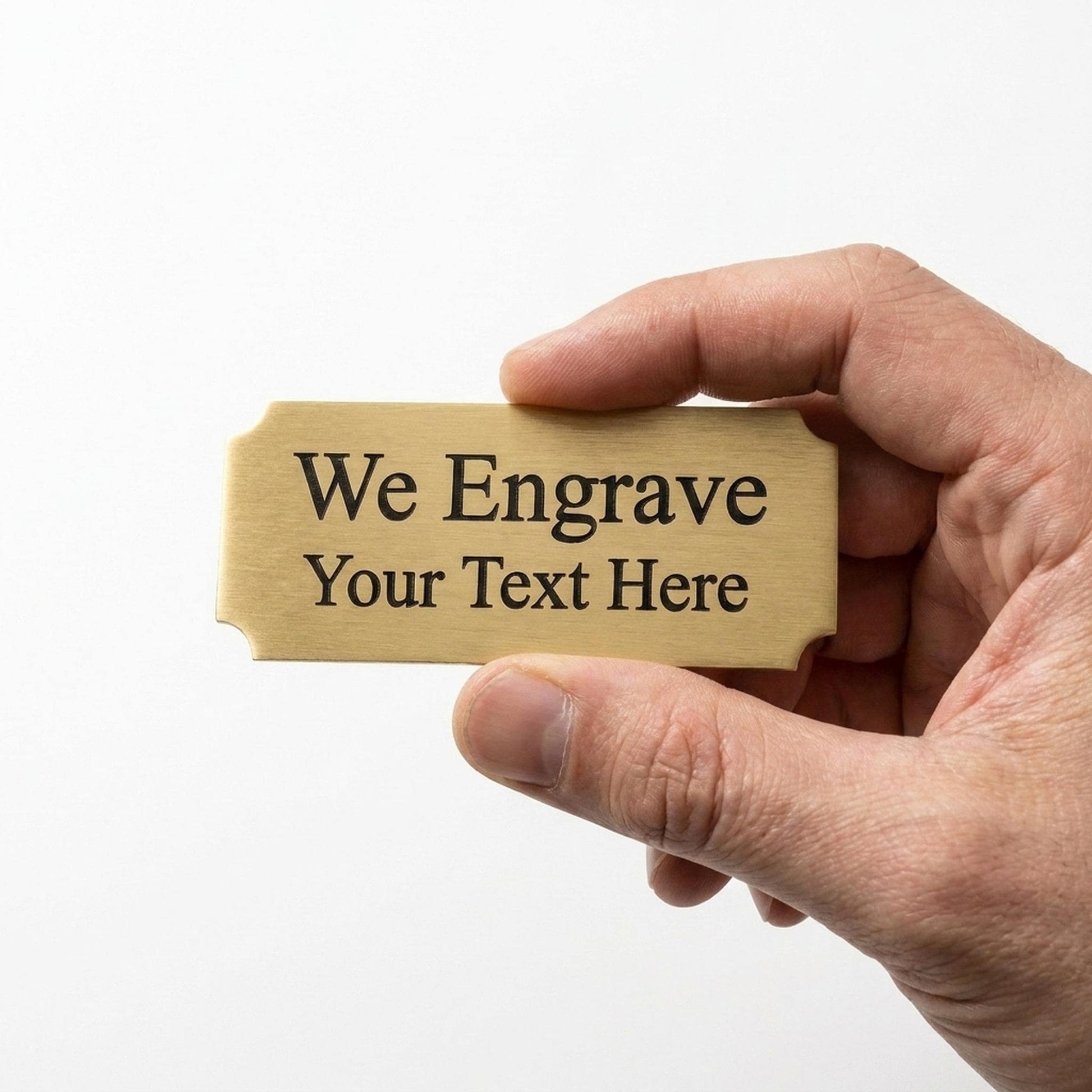 Hand holding a personalized engraved brass nameplate