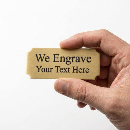 Hand holding a personalized engraved brass nameplate