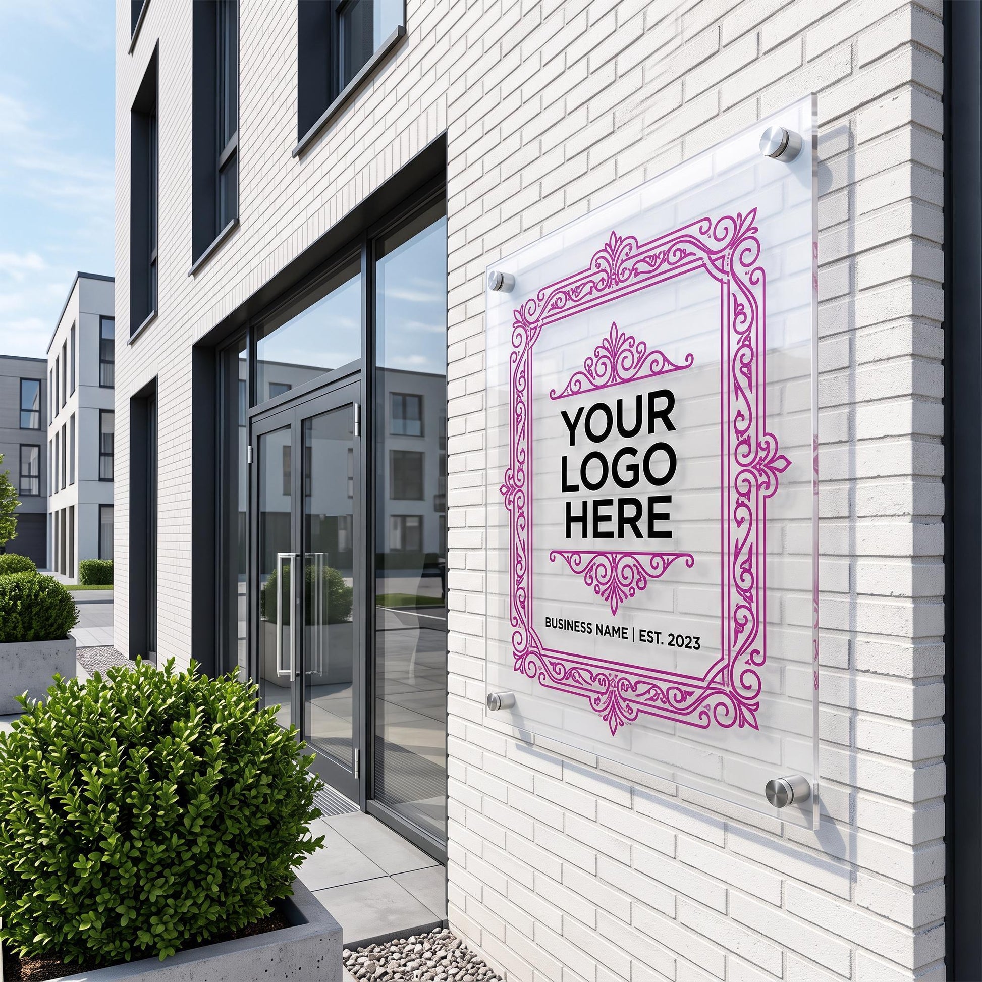 Custom acrylic business logo sign with ornate frame design mounted on an exterior brick storefront wall