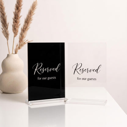 Two acrylic color options for the table sign: black acrylic with white text and clear acrylic with black text.