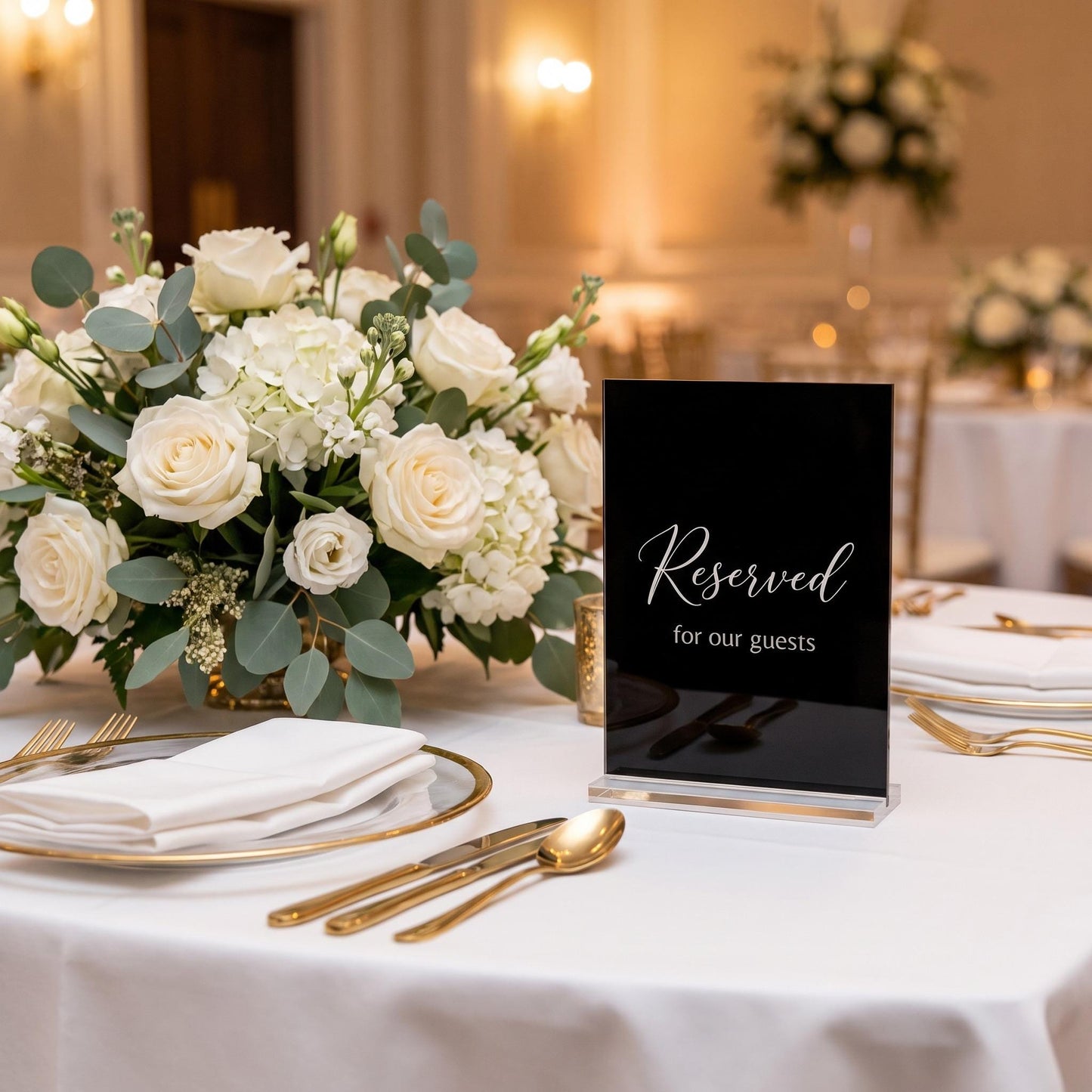 Custom acrylic table sign displayed at a place setting on an elegant reception table.