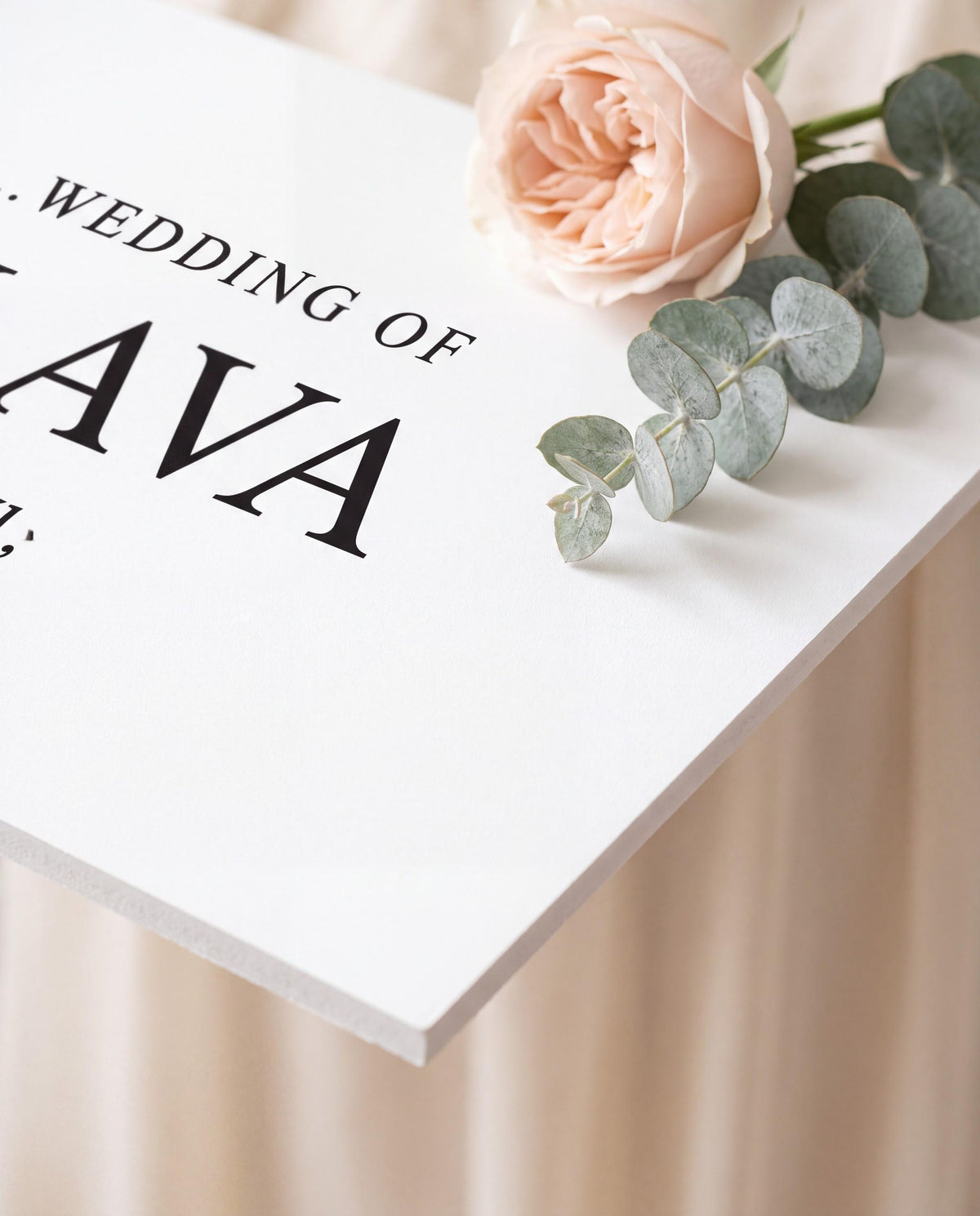 Close up of matte wedding sign edge with rose and eucalyptus showing print detail