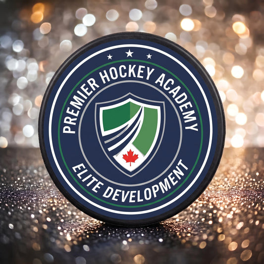 Close-up of custom hockey puck showing detailed printed navy and green crest logo with maple leaf emblem