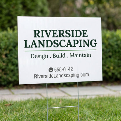 Custom yard sign for a landscaping business mounted on wire H-stake in green grass with hedge background