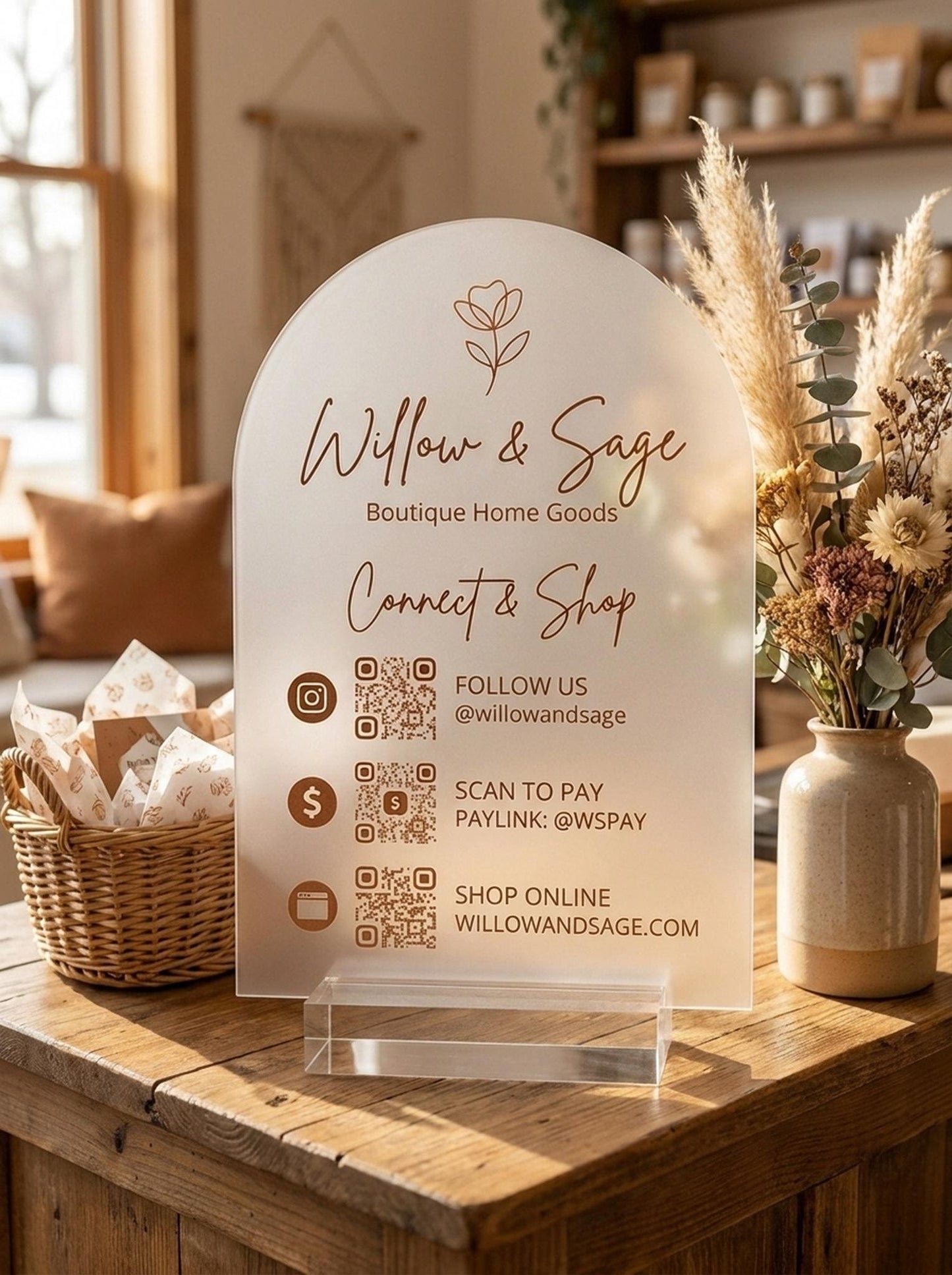 Custom QR code acrylic sign displayed on a boutique shop counter with dried flowers