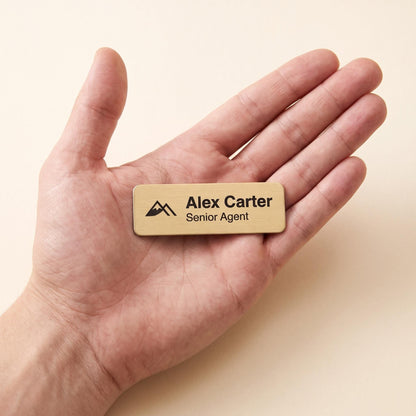Custom name badge resting on an open palm to show its compact size.