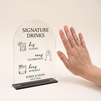 Custom acrylic bar sign on its stand next to a hand to show its tabletop size.