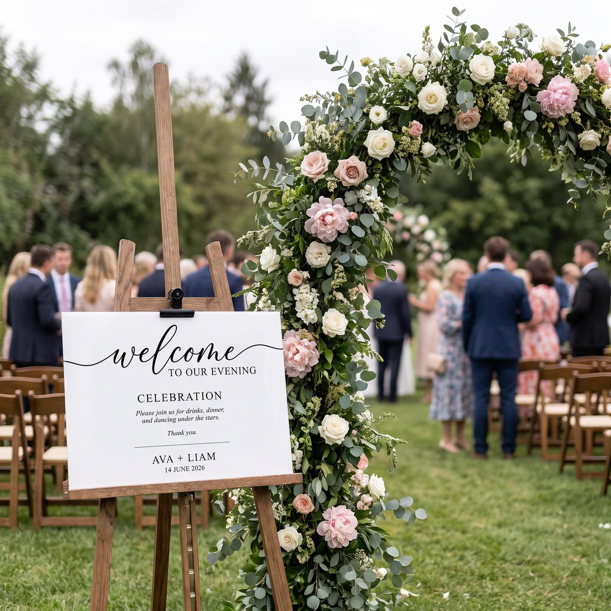 Custom acrylic welcome sign on its wood easel positioned at an outdoor ceremony entrance.