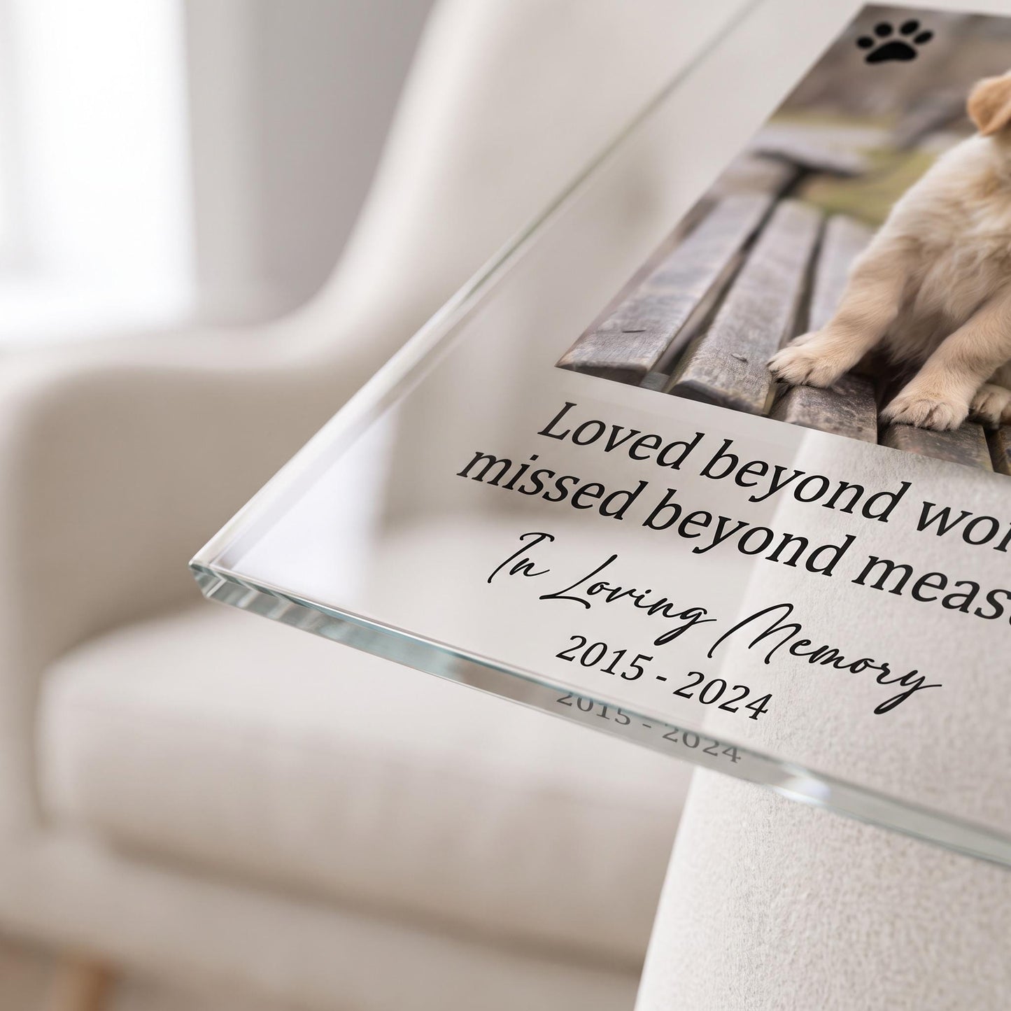 Close-up of the memorial plaque showing the printed verse text and paw print icon detail.